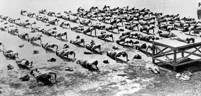 Vintage Soldiers doing push ups in formation.