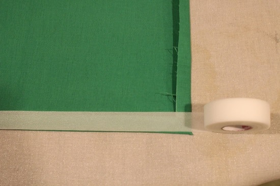 Cut your hem tape according to the length of your pocket square. You can also see that it's wider than the 1/2-inch hem, so I cut the tape in half the long way.